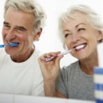 Happy Couple Brushing Teeth